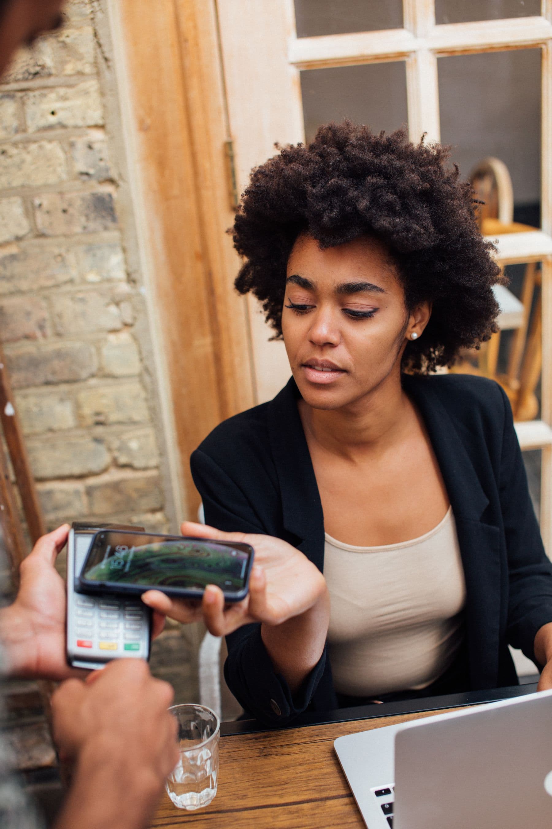 Customer paying by phone at a cafe